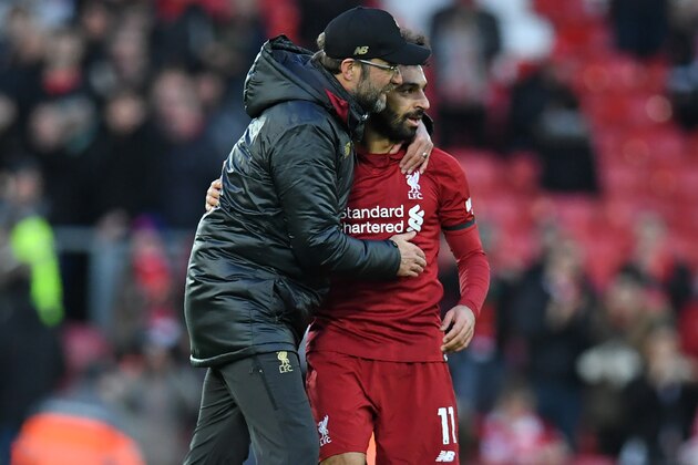Liverpool's German manager Jurgen Klopp congratulates Liverpool's Egyptian midfielder Mohamed Salah (R) on the pitch after the English Premier League football match between Liverpool and Bournemouth at Anfield in Liverpool, north west England on February 9, 2019. - Liverpool won the game 3-0. (Photo by Paul ELLIS / AFP) / RESTRICTED TO EDITORIAL USE. No use with unauthorized audio, video, data, fixture lists, club/league logos or 'live' services. Online in-match use limited to 120 images. An additional 40 images may be used in extra time. No video emulation. Social media in-match use limited to 120 images. An additional 40 images may be used in extra time. No use in betting publications, games or single club/league/player publications. /         (Photo credit should read PAUL ELLIS/AFP/Getty Images)