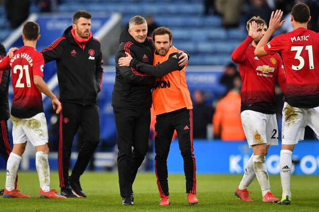 Manchester United's  Norwegian caretaker manager Ole Gunnar Solskjaer (C) embraces Manchester United's Spanish midfielder Juan Mata on the pitch after the English Premier League football match between Leicester City and Manchester United at King Power Stadium in Leicester, central England on February 3, 2019. (Photo by Ben STANSALL / AFP) / RESTRICTED TO EDITORIAL USE. No use with unauthorized audio, video, data, fixture lists, club/league logos or 'live' services. Online in-match use limited to 120 images. An additional 40 images may be used in extra time. No video emulation. Social media in-match use limited to 120 images. An additional 40 images may be used in extra time. No use in betting publications, games or single club/league/player publications. /         (Photo credit should read BEN STANSALL/AFP/Getty Images)