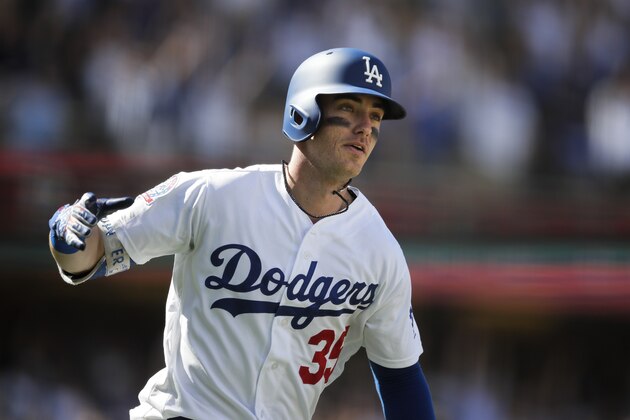 Los Angeles Dodgers' Cody Bellinger watches the flight of his two-run home run during the fourth inning of a tiebreaker baseball game against the Colorado Rockies, Monday, Oct. 1, 2018, in Los Angeles. (AP Photo/Jae C. Hong)