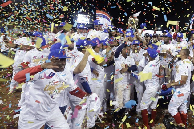 Panama's Los Toros de Herrera baseball players celebrate their 3-0 victory over Cuba's Los Leneros de las Tunas amid confetti at the end of the Caribbean Series baseball tournament's final, championship game at Rod Carew stadium in Panama City, Sunday, Feb. 10, 2019. (AP Photo/Arnulfo Franco)