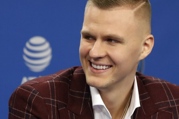Dallas Mavericks' Kristaps Porzingis smiles as he responds to questions during a news conference where the newly acquired players were introduced in Dallas, Monday, Feb. 4, 2019. (AP Photo/Tony Gutierrez)
