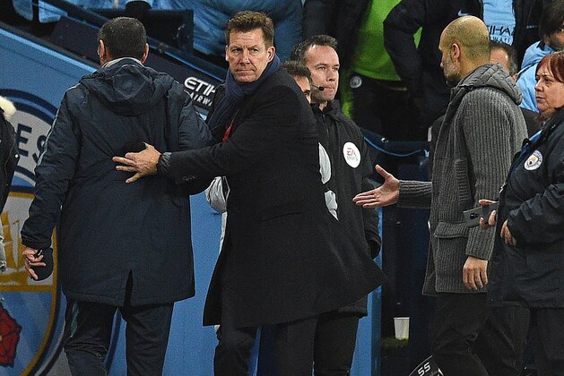 Chelsea's Italian head coach Maurizio Sarri (L) leaves the pitch as Manchester City's Spanish manager Pep Guardiola (R) shakes hands with Chelsea's Italian assistant first team coach Gianfranco Zola following the English Premier League football match between Manchester City and Chelsea at the Etihad Stadium in Manchester, north west England, on February 10, 2019. - Manchester City won the match 6-0. (Photo by Oli SCARFF / AFP) / RESTRICTED TO EDITORIAL USE. No use with unauthorized audio, video, data, fixture lists, club/league logos or 'live' services. Online in-match use limited to 120 images. An additional 40 images may be used in extra time. No video emulation. Social media in-match use limited to 120 images. An additional 40 images may be used in extra time. No use in betting publications, games or single club/league/player publications. /         (Photo credit should read OLI SCARFF/AFP/Getty Images)