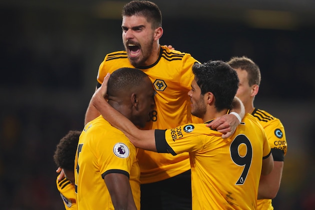 WOLVERHAMPTON, ENGLAND - FEBRUARY 11:  Willy Boly of Wolverhampton Wanderers celebrates with Ruben Neves (top) and team mates as he scores his team's first goal during the Premier League match between Wolverhampton Wanderers and Newcastle United at Molineux on February 11, 2019 in Wolverhampton, United Kingdom.  (Photo by Catherine Ivill/Getty Images)
