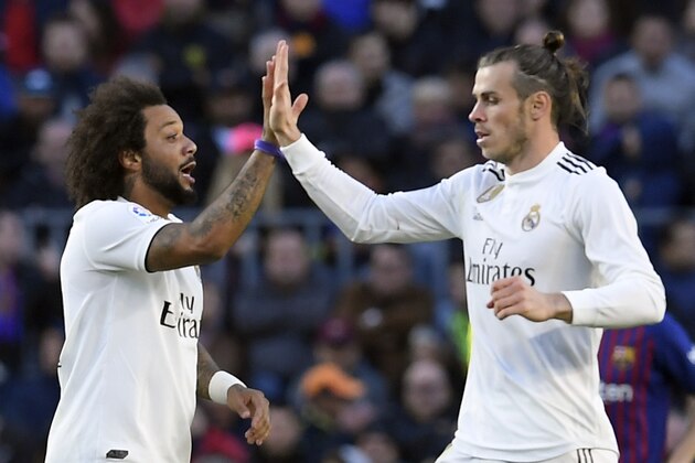 Real Madrid's Brazilian defender Marcelo (L) celebrates his goal with Real Madrid's Welsh forward Gareth Bale during the Spanish league football match between FC Barcelona and Real Madrid CF at the Camp Nou stadium in Barcelona on October 28, 2018. (Photo by LLUIS GENE / AFP)        (Photo credit should read LLUIS GENE/AFP/Getty Images)