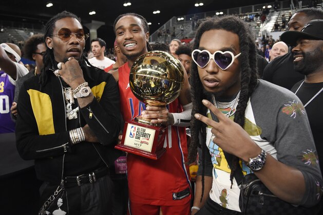 Rapper Quavo, center, the MVP of the NBA All-Star celebrity basketball game, holds his trophy as he poses with his Migos bandmates Offset, left, and Takeoff following the game Friday, Feb. 16, 2018, in Los Angeles. (AP Photo/Chris Pizzello)