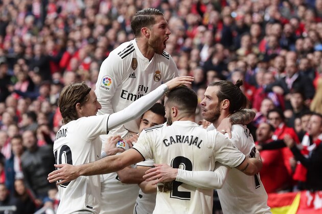 Real Madrid's Gareth Bale, right, celebrates with team mates after scoring his side's 3rd goal during a Spanish La Liga soccer match between Atletico Madrid and Real Madrid at the Metropolitano stadium in Madrid, Spain, Saturday, Feb. 9, 2019. (AP Photo/Manu Fernandez)
