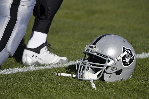 An Oakland Raiders helmet is on the playing field before an NFL football game against the Kansas City Chiefs in Kansas City, Mo., Sunday, Dec. 10, 2017. (AP Photo/Ed Zurga)