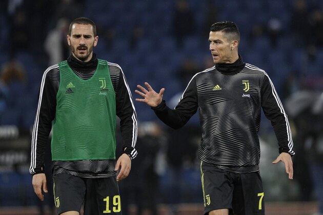 Juventus' Cristiano Ronaldo, right, talks with his teammate Leonardo Bonucci as they warm up prior to the start of the Serie A soccer match between Lazio and Juventus at the Olympic stadium, in Rome, Sunday, Jan. 27, 2019. (AP Photo/Gregorio Borgia)