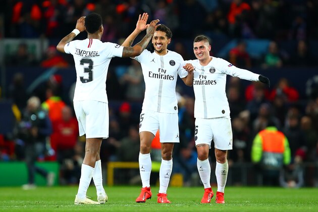 MANCHESTER, ENGLAND - FEBRUARY 12:  Marco Verrati and Marquinhos of Paris Saint-Germain celebrate with Presnel Kimpembe after Paris Saint-Germain's second goal during the UEFA Champions League Round of 16 First Leg match between Manchester United and Paris Saint-Germain at Old Trafford on February 12, 2019 in Manchester, England. (Photo by Robbie Jay Barratt - AMA/Getty Images)