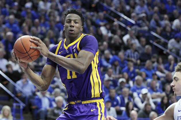LSU's Kavell Bigby-Williams, left, pulls down a rebound near Kentucky's Reid Travis, right, during the first half of an NCAA college basketball game in Lexington, Ky., Tuesday, Feb. 12, 2019. (AP Photo/James Crisp)