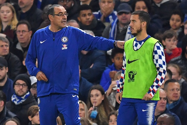 Chelsea's Italian head coach Maurizio Sarri (L) speaks with Chelsea's Belgian midfielder Eden Hazard (R) as he prepares to come on as a substitute during the English Premier League football match between Chelsea and Crystal Palace at Stamford Bridge in London on November 4, 2018. (Photo by Ben STANSALL / AFP) / RESTRICTED TO EDITORIAL USE. No use with unauthorized audio, video, data, fixture lists, club/league logos or 'live' services. Online in-match use limited to 120 images. An additional 40 images may be used in extra time. No video emulation. Social media in-match use limited to 120 images. An additional 40 images may be used in extra time. No use in betting publications, games or single club/league/player publications. /         (Photo credit should read BEN STANSALL/AFP/Getty Images)