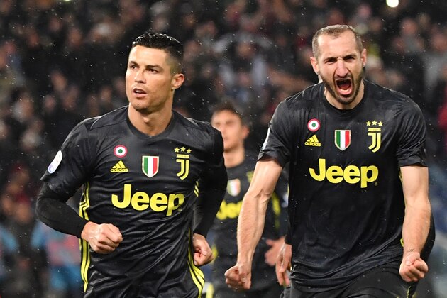 Juventus' Portuguese forward Cristiano Ronaldo (L) and Juventus' Italian defender Giorgio Chiellini celebrate after Ronaldo scored a penalty during the italian Serie A football match Lazio Roma vs Juventus on January 27, 2019 at the Olympic stadium in Rome. (Photo by Andreas SOLARO / AFP)        (Photo credit should read ANDREAS SOLARO/AFP/Getty Images)