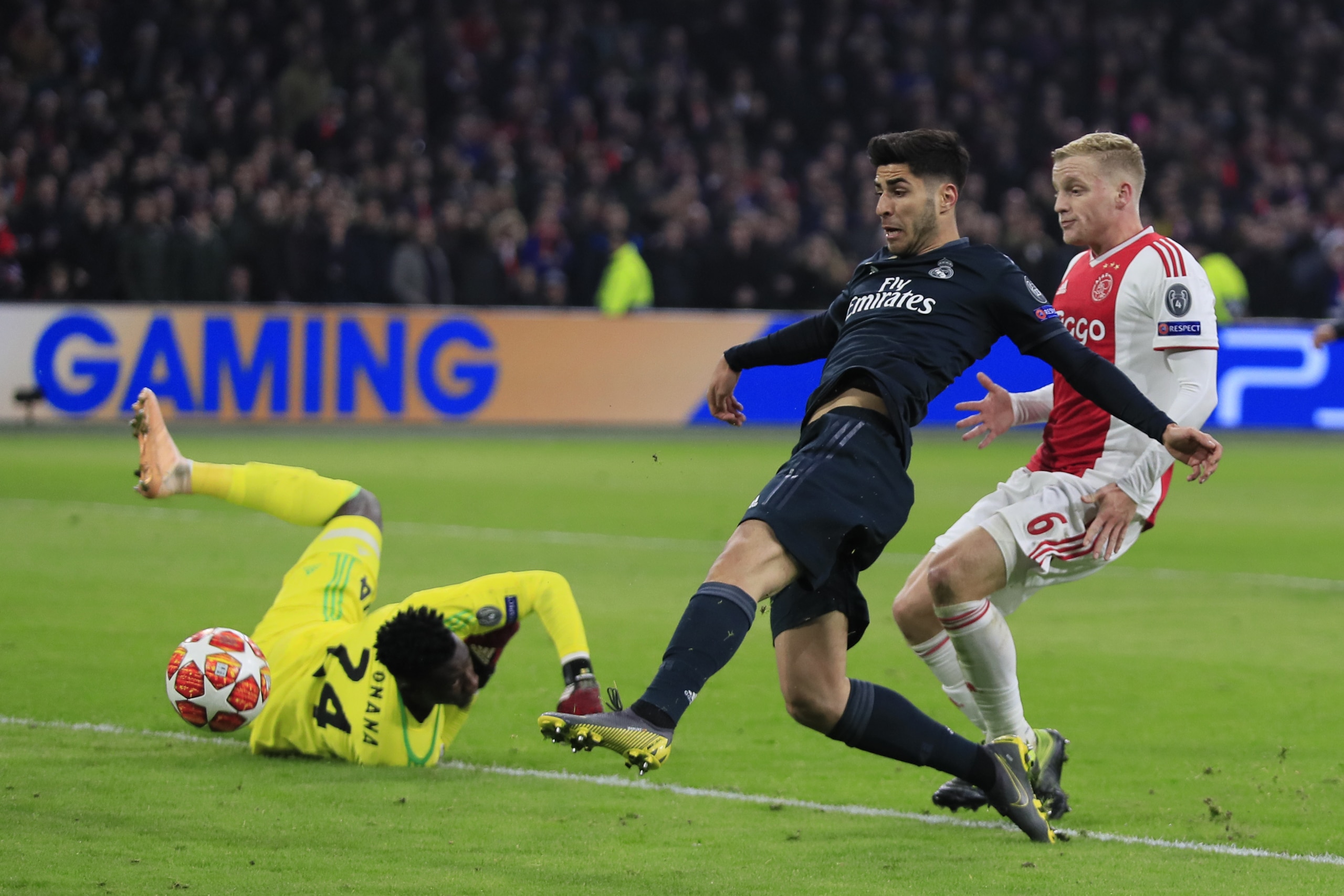 Real midfielder Marco Asensio, center, scores his side's second goal during the first leg, round of sixteen, Champions League soccer match between Ajax and Real Madrid at the Johan Cruyff ArenA in Amsterdam, Netherlands, Wednesday Feb. 13, 2019. (AP Photo/Peter Dejong) Real midfielder Marco Asensio, center, scores his side's second goal during the first leg, round of sixteen, Champions League soccer match between Ajax and Real Madrid at the Johan Cruyff ArenA in Amsterdam, Netherlands, Wednesday Feb. 13, 2019. (AP Photo/Peter Dejong)