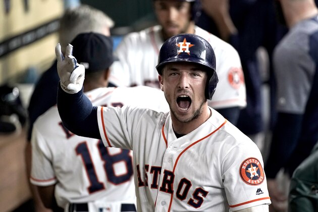 Houston Astros' Alex Bregman celebrates in the dugout after hitting a two-run home run against the Boston Red Sox during the third inning of a baseball game Saturday, June 2, 2018, in Houston. (AP Photo/David J. Phillip)