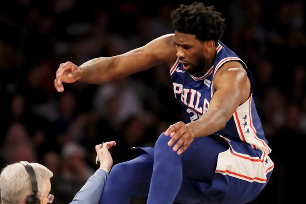 NEW YORK, NEW YORK - FEBRUARY 13:   Joel Embiid #21 of the Philadelphia 76ers leaps over the first row in attempt to keep the ball in bounds in the second half against the New York Knicks at Madison Square Garden on February 13, 2019 in New York City. NOTE TO USER: User expressly acknowledges and agrees that, by downloading and or using this photograph, User is consenting to the terms and conditions of the Getty Images License Agreement. (Photo by Elsa/Getty Images)
