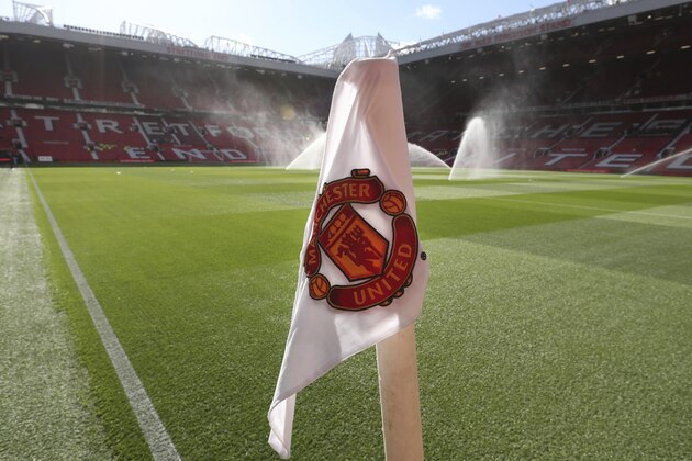 A corner flag with the logo of the Manchester United soccer team on it as the pitch is warted ahead of the English Premier League soccer match between Manchester United and Leicester City at Old Trafford, in Manchester, England, Friday, Aug. 10, 2018. (AP Photo/Jon Super)