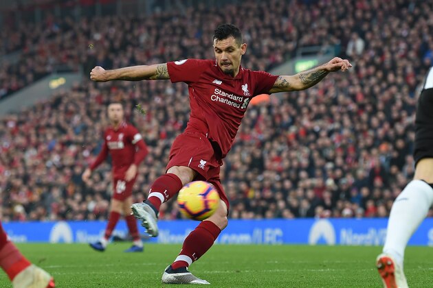 Liverpool's Croatian defender Dejan Lovren shoots to score the opening goal of the English Premier League football match between Liverpool and Newcastle United at Anfield in Liverpool, north west England on December 26, 2018. (Photo by Paul ELLIS / AFP) / RESTRICTED TO EDITORIAL USE. No use with unauthorized audio, video, data, fixture lists, club/league logos or 'live' services. Online in-match use limited to 120 images. An additional 40 images may be used in extra time. No video emulation. Social media in-match use limited to 120 images. An additional 40 images may be used in extra time. No use in betting publications, games or single club/league/player publications. /         (Photo credit should read PAUL ELLIS/AFP/Getty Images)