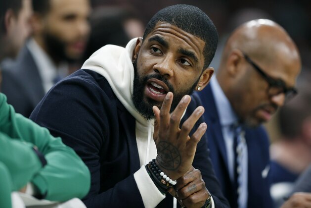 Boston Celtics' Kyrie Irving, who did not play, sits on the bench during the first half of an NBA basketball game against the Detroit Pistons in Boston, Wednesday, Feb. 13, 2019. (AP Photo/Michael Dwyer)