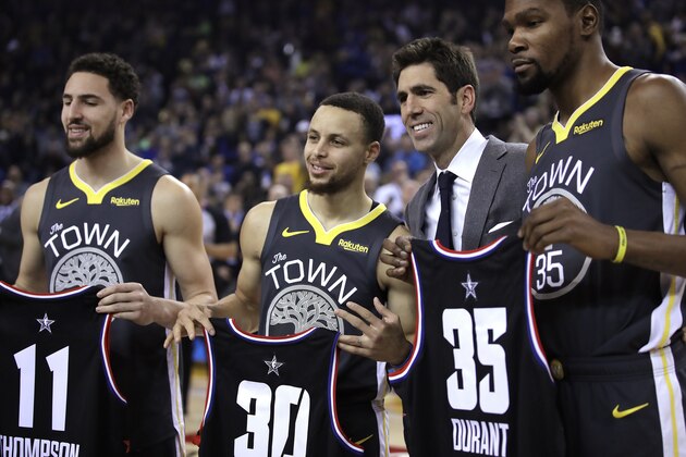 Golden State Warriors general manager Bob Myers, third from left, presents All-Star jerseys to Klay Thompson (11), Stephen Curry (30) and Kevin Durant (35) prior to an NBA basketball game against the Utah Jazz, Tuesday, Feb. 12, 2019, in Oakland, Calif. (AP Photo/Ben Margot)