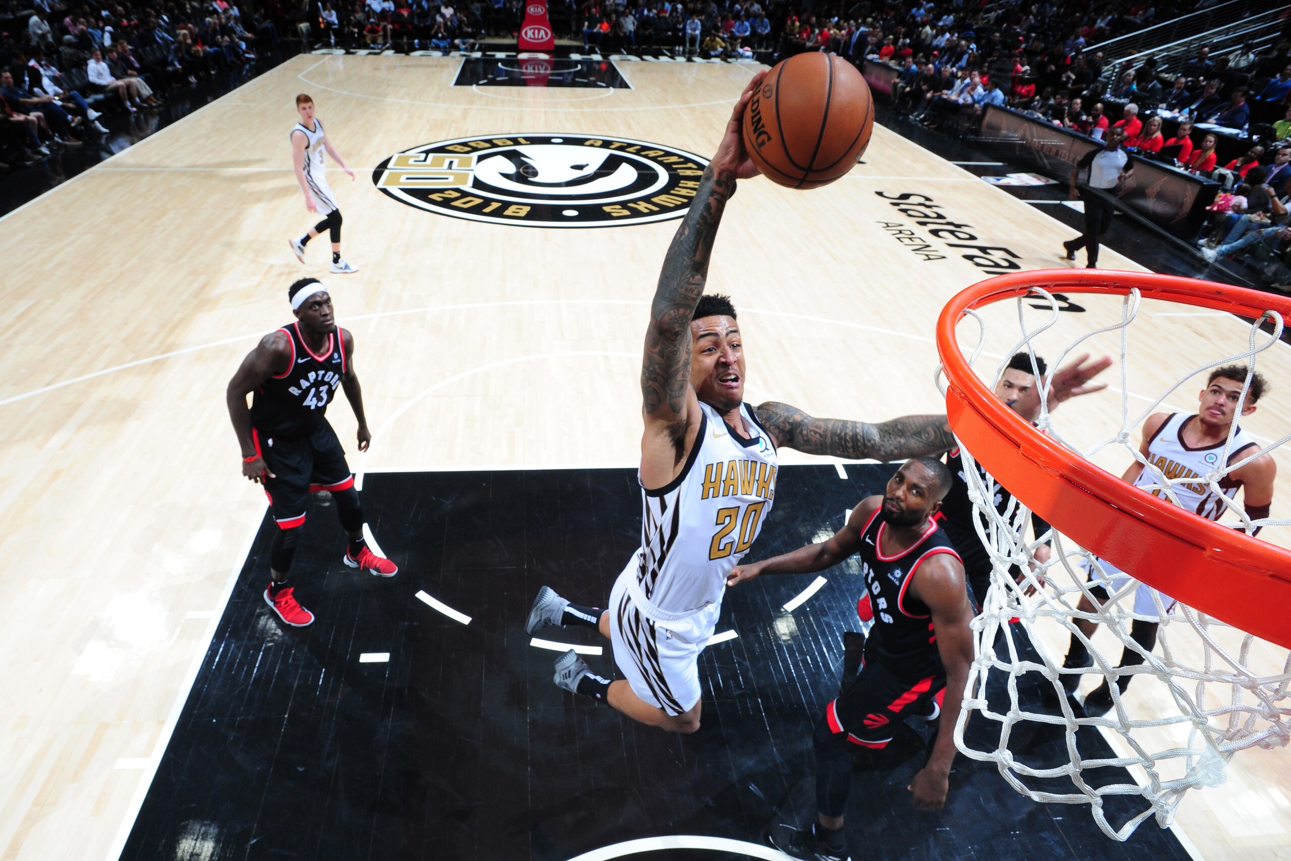 ATLANTA, GA - FEBRUARY 7: John Collins #20 of the Atlanta Hawks goes up for dunk against the Toronto Raptors on February 7, 2019 at State Farm Arena in Atlanta, Georgia.  NOTE TO USER: User expressly acknowledges and agrees that, by downloading and/or using this Photograph, user is consenting to the terms and conditions of the Getty Images License Agreement. Mandatory Copyright Notice: Copyright 2019 NBAE (Photo by Scott Cunningham/NBAE via Getty Images)