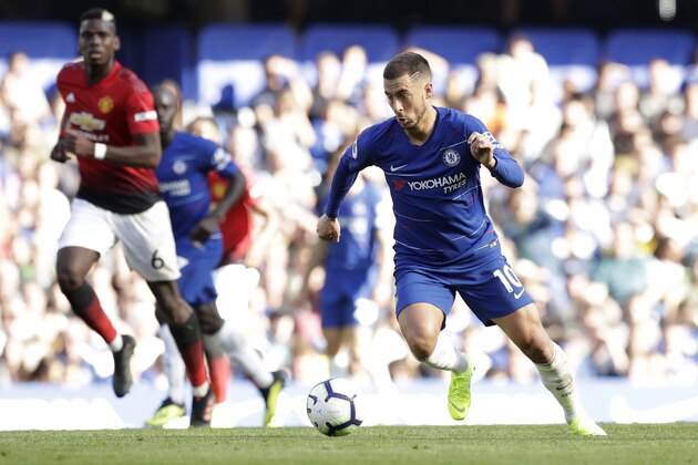 Chelsea's Eden Hazard pushes forward as ManU midfielder Paul Pogba, left, runs alongside during their English Premier League soccer match between Chelsea and Manchester United at Stamford Bridge stadium in London Saturday, Oct. 20, 2018. (AP Photo/Matt Dunham)