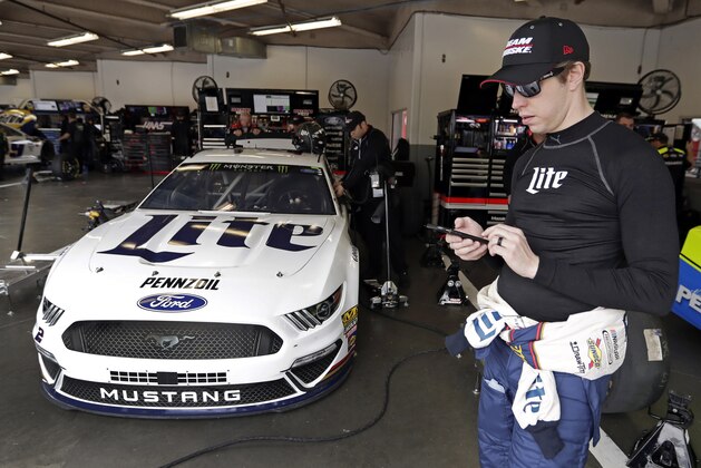 Brad Keselowski waits by his car as his crew makes adjustments before a NASCAR auto race practice session at Daytona International Speedway, Saturday, Feb. 9, 2019, in Daytona Beach, Fla. (AP Photo/John Raoux)