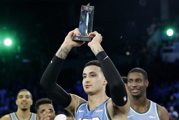 U.S. Team's Kyle Kuzma, of the Los Angeles Lakers holds the MVP trophy after the NBA All-Star Rising Stars basketball game between the World Team and the U.S. Team, Friday, Feb. 15, 2019, in Charlotte, N.C. The U.S. Team won 161-144. (AP Photo/Chuck Burton)