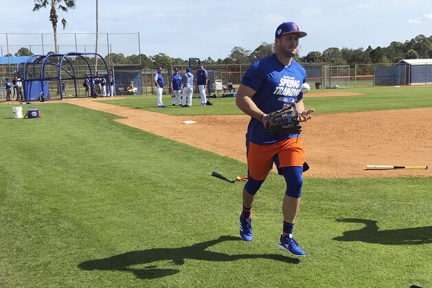 New York Mets' Tim Tebow jogs up the first baseline at spring training baseball practice Saturday, Feb. 16, 2019, in Port St. Lucie, Fla. (AP Photo/Mike Fitzpatrick)