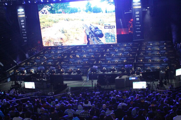 Fans watch as 80 players simultaneously fight for survival in an eSports match of upstart computer game PlayUnknown's Battlegrounds at an Intel Extreme Masters tournament in the Oracle Arena in Oakland, California on November 18, 2017.
Scores of virtual warriors faced-off in a Hunger Games-style death match here in a massive, real-world eSports match-up of upstart shooter game 'PlayerUnknown's Battlegrounds.' The computer game's rise has been epic, with some industry trackers branding this the year of 'PUBG' even though it is technically still in trial mode with a final version yet to be released.In a colossal  two-day event that ended late Sunday, 80 players hunched over computers in a warren of cubicles set up in an arena where the champion Golden State Warriors usually play home basketball games.
 / AFP PHOTO / Glenn CHAPMAN        (Photo credit should read GLENN CHAPMAN/AFP/Getty Images)