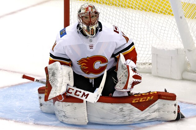 Calgary Flames goaltender Mike Smith keeps his eye on a rebound during the first period of an NHL hockey game against the Pittsburgh Penguins in Pittsburgh, Saturday, Feb. 16, 2019. The Flames won 5-4. (AP Photo/Gene J. Puskar)