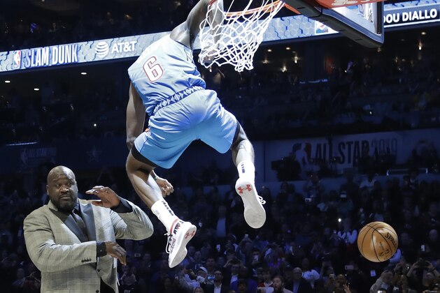 Oklahoma City Thunder Hamidou Diallo leaps over former NBA player Shaquille O'Neal during the NBA All-Star Slam Dunk contest, Saturday, Feb. 16, 2019, in Charlotte, N.C. Diallo won the contest. (AP Photo/Chuck Burton)