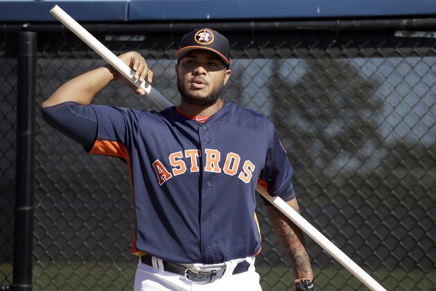 Houston Astros pitcher Josh James uses a bar to stretch during spring training baseball practice Friday, Feb. 15, 2019, in West Palm Beach, Fla. (AP Photo/Jeff Roberson)