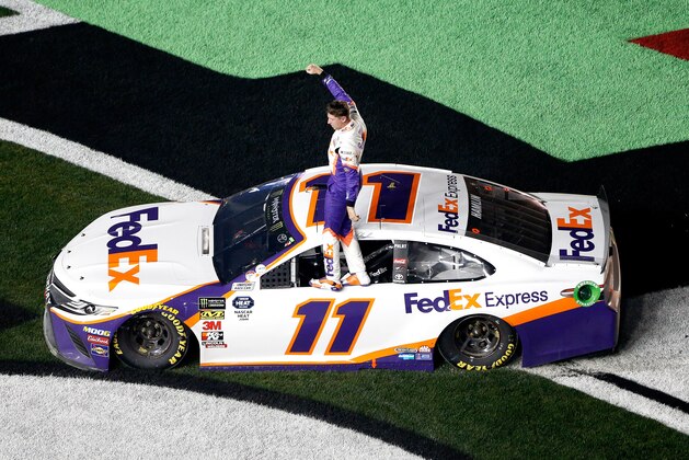 DAYTONA BEACH, FL - FEBRUARY 17:  Denny Hamlin, driver of the #11 FedEx Express Toyota, celebrates winning the Monster Energy NASCAR Cup Series 61st Annual Daytona 500 at Daytona International Speedway on February 17, 2019 in Daytona Beach, Florida.  (Photo by Brian Lawdermilk/Getty Images)