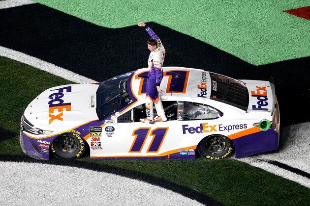 DAYTONA BEACH, FL - FEBRUARY 17:  Denny Hamlin, driver of the #11 FedEx Express Toyota, celebrates winning the Monster Energy NASCAR Cup Series 61st Annual Daytona 500 at Daytona International Speedway on February 17, 2019 in Daytona Beach, Florida.  (Photo by Brian Lawdermilk/Getty Images)