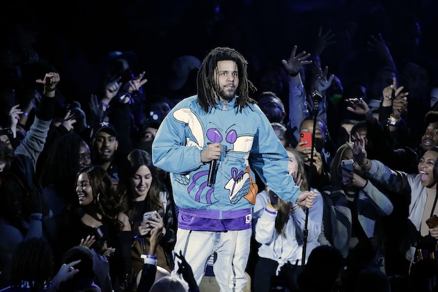 Rapper J. Cole performs at halftime during NBA All-Star basketball game, Sunday, Feb. 17, 2019, in Charlotte, N.C. (AP Photo/Gerry Broome)