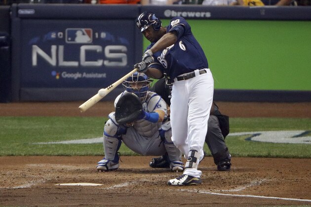 Milwaukee Brewers' Lorenzo Cain (6) hits a double during the fifth inning of Game 2 of the National League Championship Series baseball game against the Los Angeles Dodgers Saturday, Oct. 13, 2018, in Milwaukee. (AP Photo/Charlie Riedel)