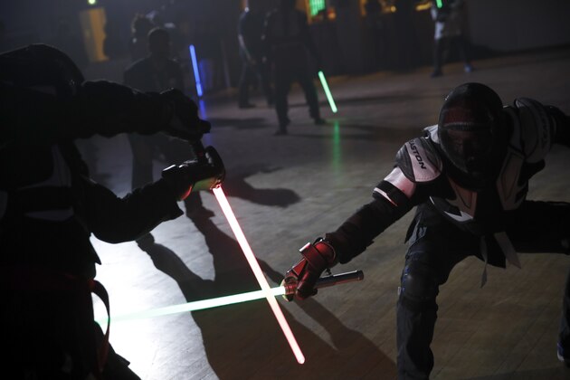 In this Sunday, Feb. 10, 2019, photo, competitors battle during a national lightsaber tournament in Beaumont-sur-Oise, north of Paris.