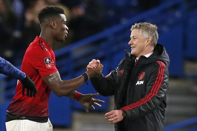 Manchester United's Norwegian caretaker manager Ole Gunnar Solskjaer (R) celebrates their victory with Manchester United's French midfielder Paul Pogba (L) on the pitch after the English FA Cup fifth round football match between Chelsea and Manchester United at Stamford Bridge in London on February 18, 2019. - Manchester United won the game 2-0. (Photo by Ian KINGTON / AFP) / RESTRICTED TO EDITORIAL USE. No use with unauthorized audio, video, data, fixture lists, club/league logos or 'live' services. Online in-match use limited to 120 images. An additional 40 images may be used in extra time. No video emulation. Social media in-match use limited to 120 images. An additional 40 images may be used in extra time. No use in betting publications, games or single club/league/player publications. / (Photo credit should read IAN KINGTON/AFP/Getty Images) Manchester United's Norwegian caretaker manager Ole Gunnar Solskjaer (R) celebrates their victory with Manchester United's French midfielder Paul Pogba (L) on the pitch after the English FA Cup fifth round football match between Chelsea and Manchester United at Stamford Bridge in London on February 18, 2019. - Manchester United won the game 2-0. (Photo by Ian KINGTON / AFP) / RESTRICTED TO EDITORIAL USE. No use with unauthorized audio, video, data, fixture lists, club/league logos or 'live' services. Online in-match use limited to 120 images. An additional 40 images may be used in extra time. No video emulation. Social media in-match use limited to 120 images. An additional 40 images may be used in extra time. No use in betting publications, games or single club/league/player publications. / (Photo credit should read IAN KINGTON/AFP/Getty Images)