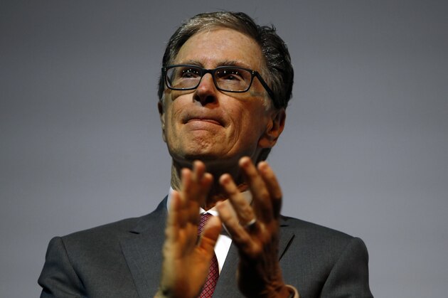 John Henry, centre, owner of the Boston Red Sox answers a question during a press conference in London, Tuesday, May 8, 2018, to announce a two game series to be played in London. The Boston Red Sox and the New York Yankees will play a MLB two game series at the London Stadium in London, June 29-30th 2019. (AP Photo/Alastair Grant)