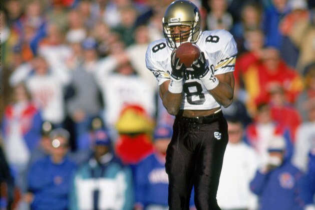 LAWRENCE, KS - NOVEMBER 14:  Defensive back T.J. Cunningham #8 of the University of Colorado at Boulder Buffaloes intercepts the ball against the University of Kansas Jayhawks at Memorial Stadium in Lawrence, Kansas, on November 14, 1992. The Buffaloes won 25-18.  (Photo by Bernstein Associates/Getty Images)