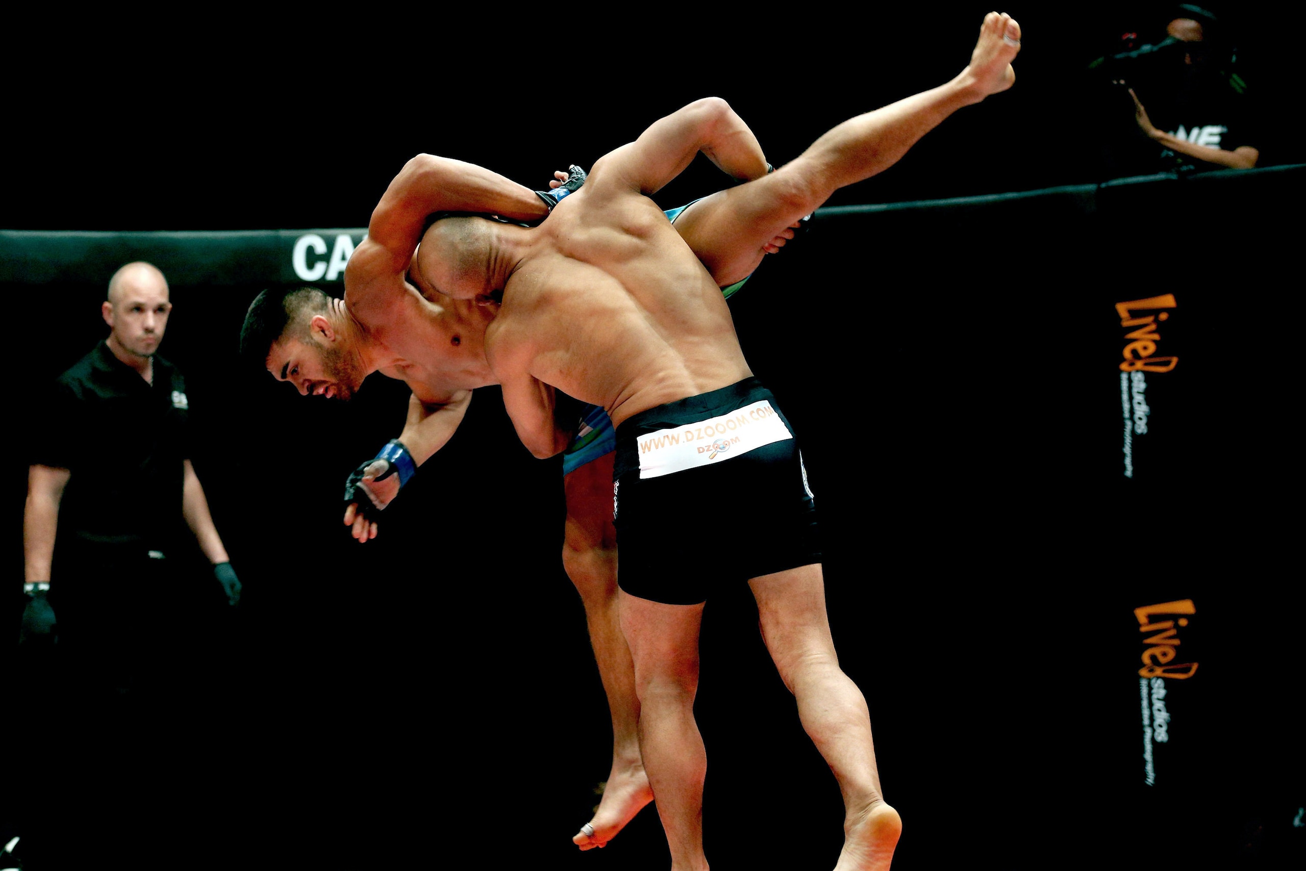 KUALA LUMPUR, MALAYSIA - MARCH 14:  Ariel Sexton of Costa Rica is thrown by Kamal Shalorus of Iran during the One FC War of Nations Lightweight Category bout  at Stadium Negara on March 14, 2014 in Kuala Lumpur, Malaysia.  (Photo by Stanley Chou/Getty Images)