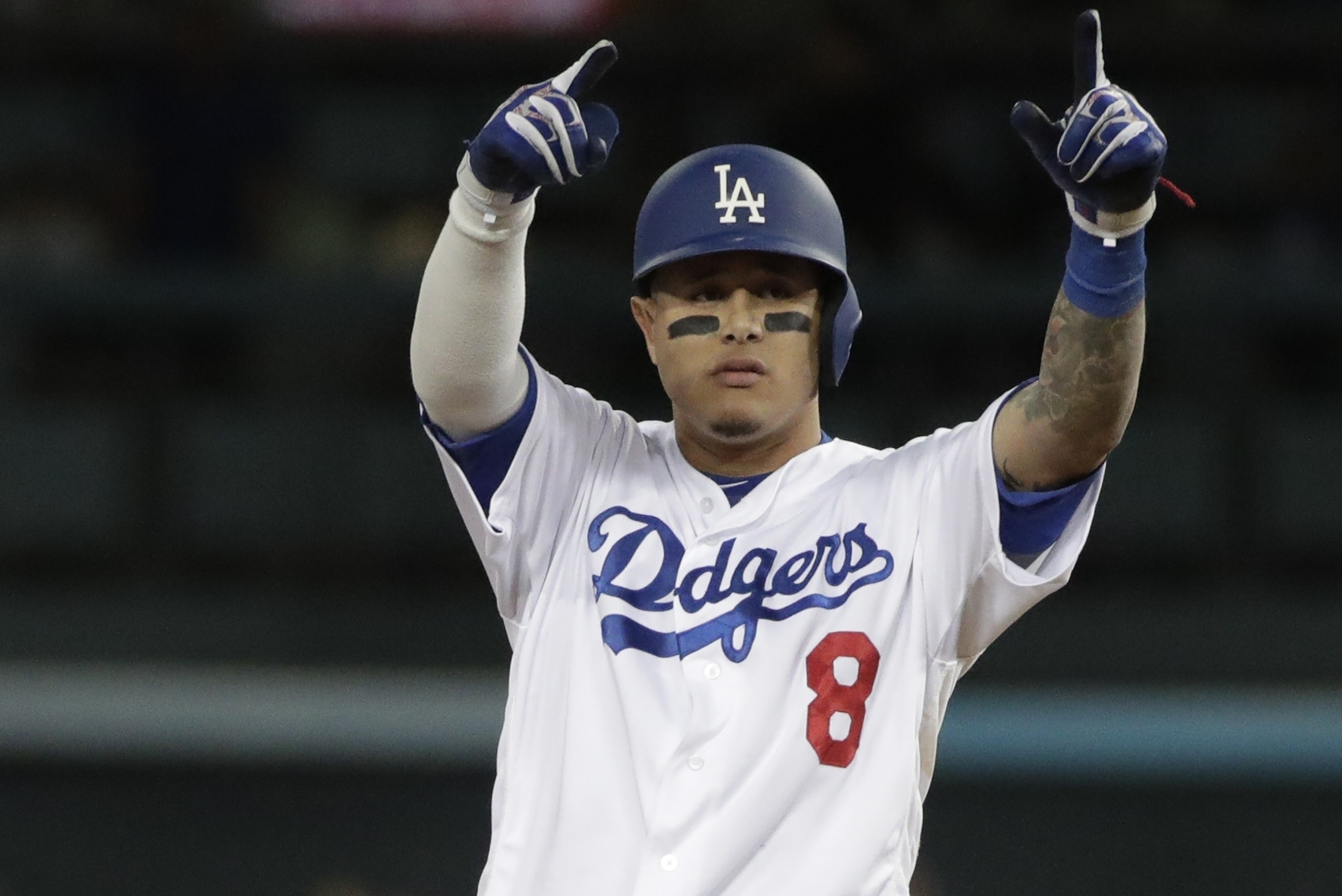 Los Angeles Dodgers' Manny Machado reacts after hitting a double during the first inning of Game 3 of the National League Championship Series baseball game Monday, Oct. 15, 2018, in Los Angeles. (AP Photo/Jae Hong) Los Angeles Dodgers' Manny Machado reacts after hitting a double during the first inning of Game 3 of the National League Championship Series baseball game Monday, Oct. 15, 2018, in Los Angeles. (AP Photo/Jae Hong)