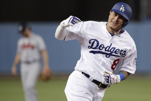 FILE - In this Oct. 5, 2018, file photo, then-Los Angeles Dodgers' Manny Machado celebrates his two-run home run against the Atlanta Braves during the first inning of Game 2 of a baseball National League Division Series, in Los Angeles. A person familiar with the negotiations tells The Associated Press that infielder Manny Machado has agreed to a $300 million, 10-year deal with the rebuilding San Diego Padres, the biggest contract ever for a free agent. The person spoke to the AP on condition of anonymity Tuesday, Feb. 19, 2019,  because the agreement was subject to a successful physical and had not been announced. (AP Photo/Jae C. Hong, File)