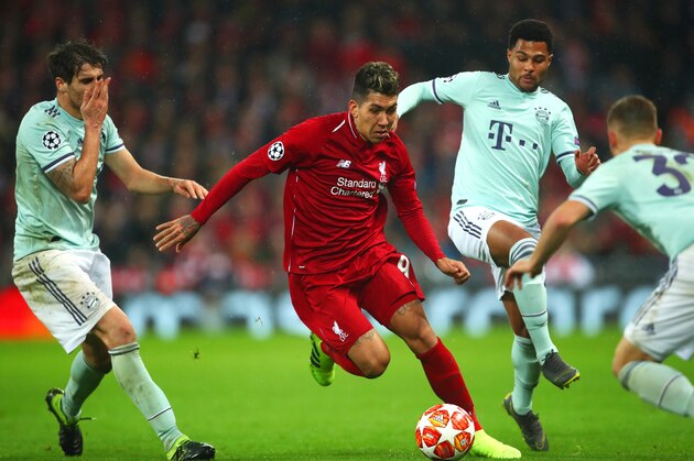 LIVERPOOL, ENGLAND - FEBRUARY 19:    Roberto Firmino of Liverpool competes with Javi Martinez of Bayern Munich during the UEFA Champions League Round of 16 First Leg match between Liverpool and FC Bayern Muenchen at Anfield on February 19, 2019 in Liverpool, England. (Photo by Robbie Jay Barratt - AMA/Getty Images)