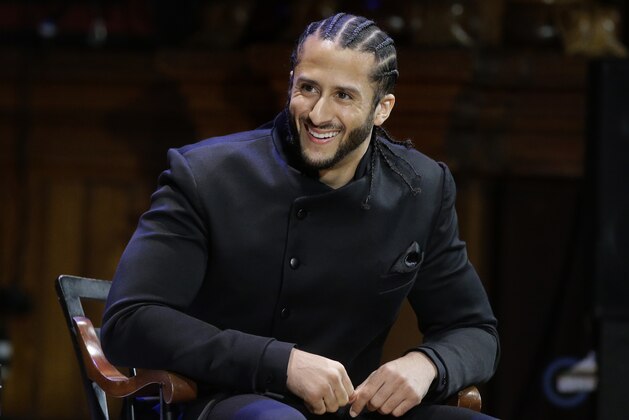 FILE - In this Oct. 11, 2018, file photo, former NFL football quarterback Colin Kaepernick smikes on stage during W.E.B. Du Bois Medal ceremonies at Harvard University, in Cambridge, Mass. Colin Kaepernick and Eric Reid have reached settlements on their collusion lawsuits against the NFL, the league said Friday, Feb. 19, 2019. (AP Photo/Steven Senne, File)