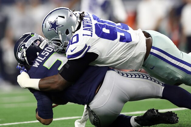 ARLINGTON, TEXAS - JANUARY 05: Russell Wilson #3 of the Seattle Seahawks is sacked by Demarcus Lawrence #90 of the Dallas Cowboys in the first half during the Wild Card Round at AT&T Stadium on January 05, 2019 in Arlington, Texas. (Photo by Ronald Martinez/Getty Images)