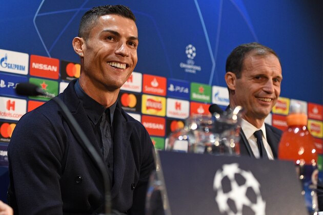 Juventus' Portuguese striker Cristiano Ronaldo (L) and Juventus' manager Massimiliano Allegri (R) attend a press conference at Old Trafford in Manchester, north west England on October 22, 2018, ahead of their UEFA Champions League group H football match against Juventus on October 23. (Photo by Oli SCARFF / AFP)        (Photo credit should read OLI SCARFF/AFP/Getty Images)