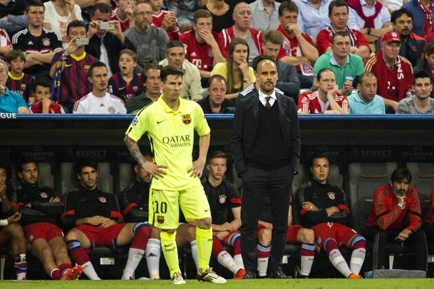 Barcelona's Argentinian forward Lionel Messi (L) and Bayern Munich's Spanish head coach Pep Guardiola stand on the pitch during the UEFA Champions League football match semi final FC Bayern Munich vs FC Barcelona in Munich on May 12, 2015.  
AFP PHOTO / ODD ANDERSEN        (Photo credit should read ODD ANDERSEN/AFP/Getty Images)