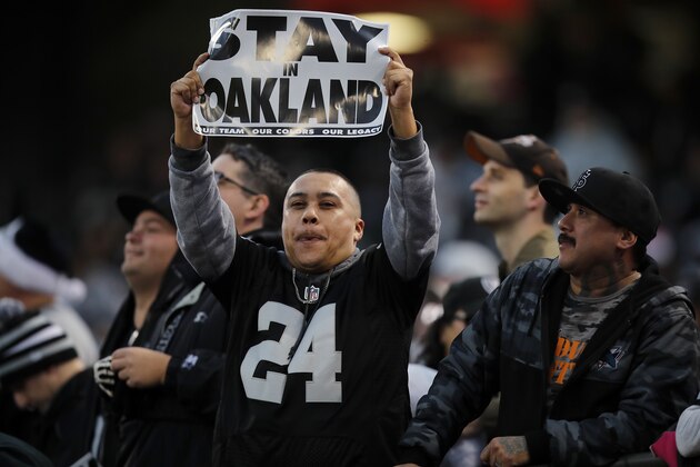 An Oakland Raiders fan holds up a sign during the first half of an NFL football game between the Raiders and the Denver Broncos in Oakland, Calif., Monday, Dec. 24, 2018. (AP Photo/John Hefti)