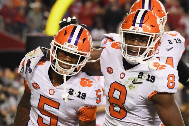 SANTA CLARA, CA - JANUARY 07:  Tee Higgins #5 of the Clemson Tigers is congratulated by his teammate Justyn Ross #8 after his third quarter touchdown against the Alabama Crimson Tide in the CFP National Championship presented by AT&T at Levi's Stadium on January 7, 2019 in Santa Clara, California.  (Photo by Harry How/Getty Images)
